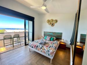 a bedroom with a bed with a view of the ocean at Aloes - Villa Salba. Panoramic view. in Étang-Salé
