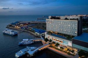 an aerial view of a hotel with boats in the water at Luxury Apartment, Harbour Bay Residences in Jodoh