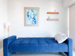 a blue couch sitting in a living room at Hermosa Suite con vista al rio! Piscina y Parqueo in Guayaquil