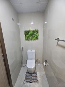 a bathroom with a white toilet and a shower at Luxe Studio Prime area near Airport & Attractions in Dubai