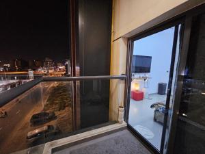 a balcony with a view of a city at night at Luxe Studio Prime area near Airport & Attractions in Dubai