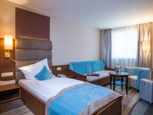 Voodi või voodid majutusasutuse Hotel König toas