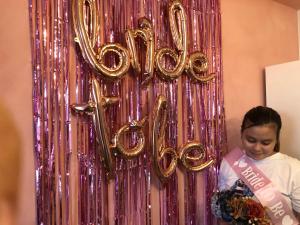 a woman standing in front of a sign that saysollywood at Staycations by SMS in Manila