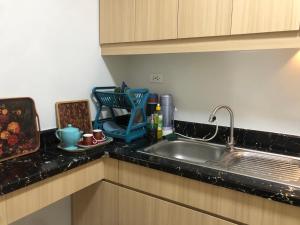 a kitchen with a sink and a counter top at Staycations by SMS in Manila