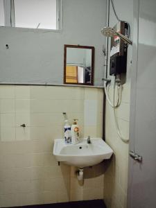 a bathroom with a sink and a mirror at SEMI-D Taman Impian, Bukit Mertajam, 15pax in Bukit Mertajam
