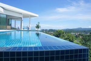 a swimming pool on the roof of a house at Serenity Villa in Bang Tao Beach