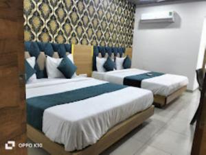 Postelja oz. postelje v sobi nastanitve Hotel Rudra Palace , Anand