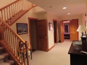 a living room with a staircase and a room with a hallway at Lux 5BR 4BA SV125 SKI In Out, 18-hole Championship Golf Course, Water Park, pet friendly in Jay