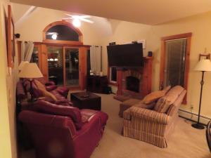 a living room with couches and a flat screen tv at Lux 5BR 4BA SV125 SKI In Out, 18-hole Championship Golf Course, Water Park, pet friendly in Jay