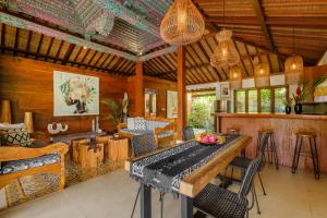 a living room with a table and chairs at Villa Asrava Ubud in Ubud +41 photos