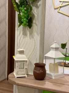 a table with a vase and a lamp on a table at Nikita's Old Tbilisi in Tbilisi City +1 photo