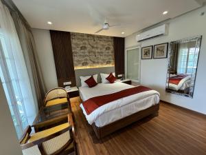 a hotel room with a bed and a table and chairs at Sky Suites By The Lazy Host in Udaipur