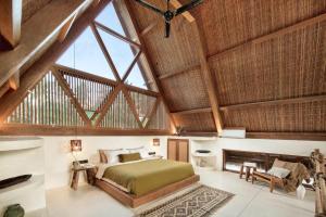 a bedroom with a bed and a vaulted ceiling at Tias Villas in Kuta Lombok