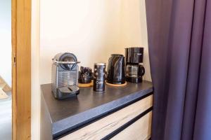 a shelf with a coffee maker and coffees on it at Chalet la Parrachée in Lanslebourg-Mont-Cenis