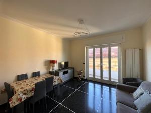 a living room with a table and a couch at Casa COCO in Imperia