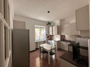 a small kitchen with a table and chairs in it at Casa COCO in Imperia