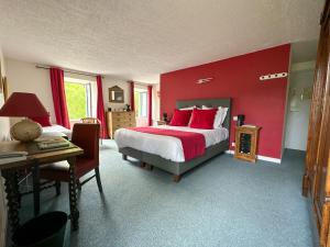 A bed or beds in a room at Logis Hôtel Le Manoir Des Portes