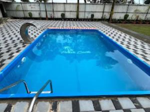 a large blue swimming pool on a tiled patio at Farm House,Palm Castle , Savarde in Alta