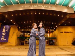 two women standing in front of a building at Nagoya Crown Hotel in Nagoya