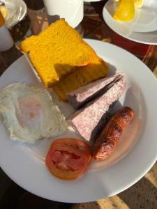 a plate with different types of food on a table at Ranges View Lodge Staycation in Kiamuturi