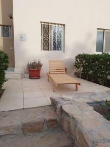 a bench sitting on a patio in front of a building at Mountain view apartment in Makadi Heights in Hurghada