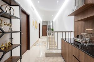 a hallway of a house with white walls and a staircase at Al Dana Paradise Luxury Villas Palm Fujairah Sea View in Fujairah