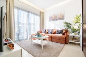 a living room with a couch and a table at Al Dana Paradise Luxury Villas Palm Fujairah Sea View in Fujairah