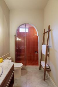 a bathroom with a shower with a toilet and a sink at Manuscript - Jhilwara Haveli in Udaipur