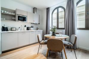 - une cuisine et une salle à manger avec une table et des chaises dans l'établissement limehome Sevilla Calle Granada, à Séville