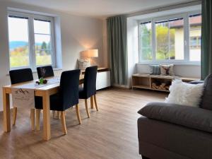 a living room with a table and chairs and a couch at Ferienwohnung Zirbenglück in Siegsdorf