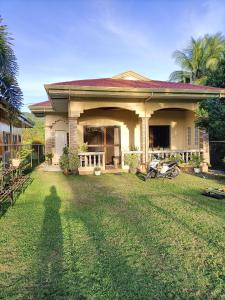 a shadow of a person standing in front of a house at Regina Vacation House in Tayud