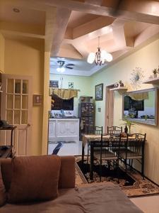 a living room with a couch and a table at Regina's Vacation House in Tayud +26 photos