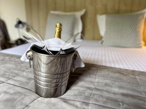 A bed or beds in a room at Logis Hôtel Le Manoir Des Portes