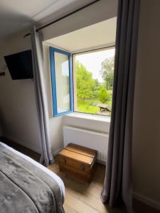 A bed or beds in a room at Logis Hôtel Le Manoir Des Portes