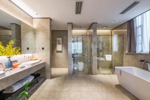 a bathroom with two sinks and a shower and a tub at Atour X Chongqing Jiefangbei pedestrian Street in Chongqing