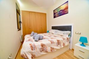 Un dormitorio con una cama con una manta. en Encantador Atico cerca de Caldea HUT 6793, en Escaldes-Engordany