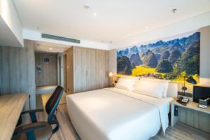 a hotel room with a bed and a desk at Atour Hotel Guiyang Convention and Exhibition Center in Guiyang