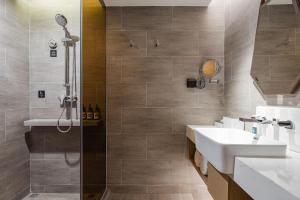 a bathroom with a shower and a sink at Atour Hotel Hangzhou Xiaoshan Airport in Xiaoshan
