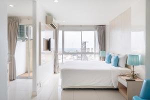 a white bedroom with a large bed and a window at Royal Pavilion Hua Hin in Hua Hin +30 photos