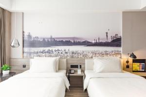 Ένα ή περισσότερα κρεβάτια σε δωμάτιο στο Atour Hotel Yingxiongshan Road Jinan +14 φωτογραφίες