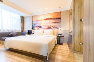 Postel nebo postele na pokoji v ubytování Atour Hotel Weihai City Center