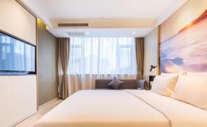 Postel nebo postele na pokoji v ubytování Atour Hotel Weihai City Center