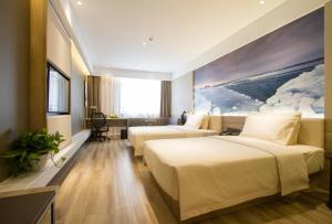 Postel nebo postele na pokoji v ubytování Atour Hotel Shenyang Hunnan Olympic Sports Center