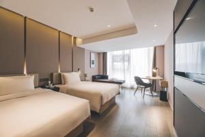 Voodi või voodid majutusasutuse Atour Hotel Huzhou Dongwu toas