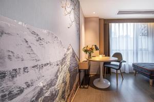 a hotel room with a wall mural of a mountain at Atour Hotel Chengdu Wenshufang in Chengdu