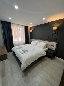 a large bedroom with a large bed with white pillows at Cosy suites hotel in Antalya
