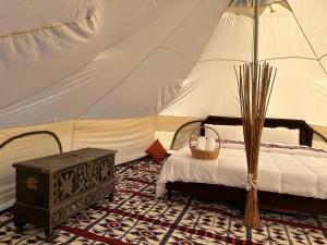 a bedroom with a bed in a tent at Thousand Stars Desert Camp in Bidiyah