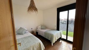 Кровать или кровати в номере Wakanda House Fuerteventura