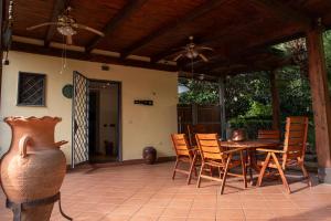 a patio with a table and chairs and a vase at Royal Palace B&B in Caserta