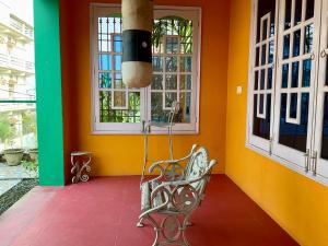 a bench in a room with colorful walls and windows at Zorba the Buddha in Begusarai